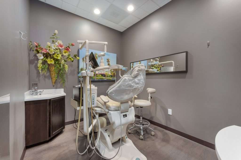 Private operatory at Sacramento Dentistry Group with a mural of the California State Capitol and floral arrangement